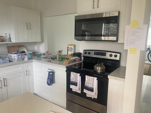 kitchen with white cabinetry and stainless steel appliances