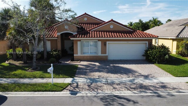 view of front of property featuring a garage and a front lawn