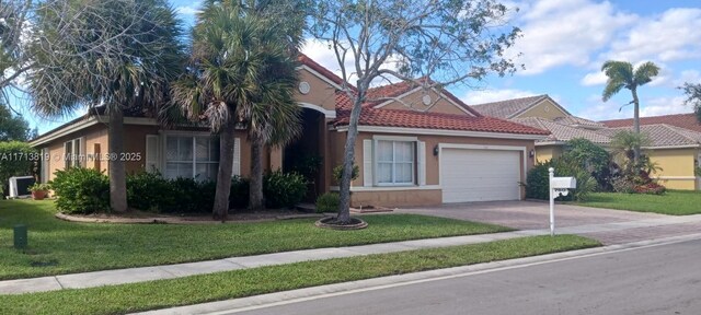 view of front of home with a garage and a front lawn