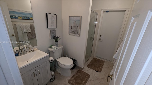 bathroom with toilet, vanity, tile patterned floors, and a shower with shower door