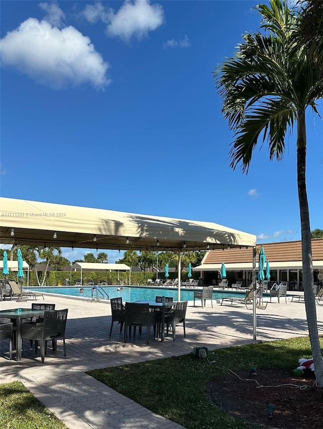 view of property's community featuring a patio and a swimming pool