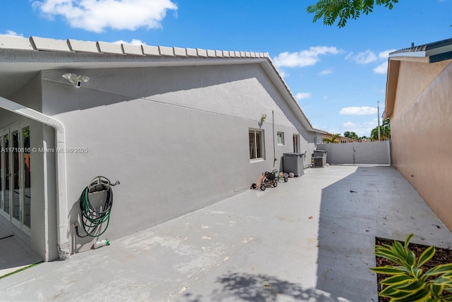 exterior space with central AC unit and a patio area