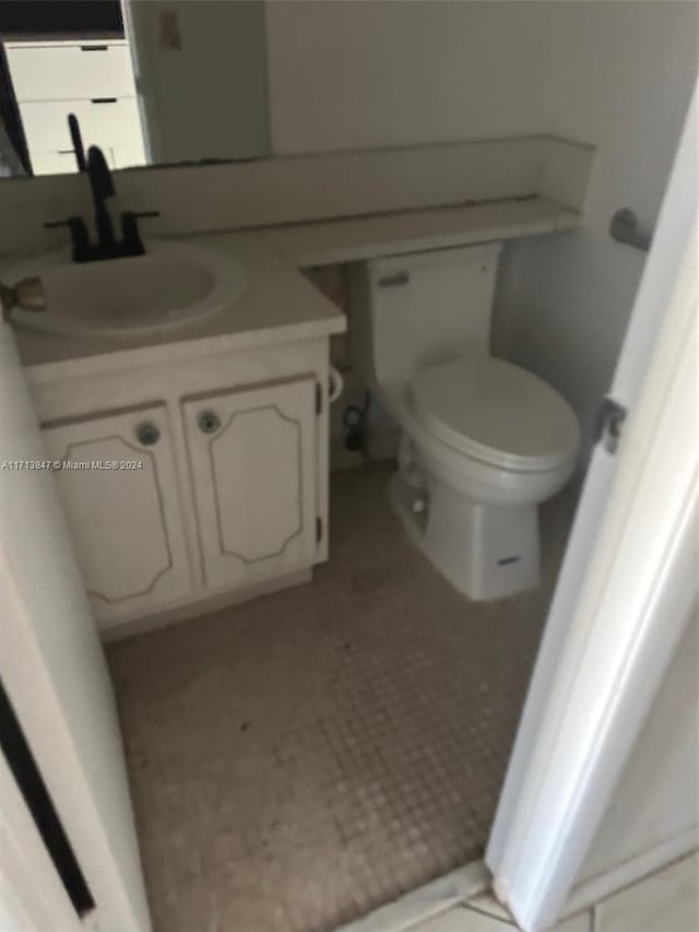 bathroom featuring vanity and toilet