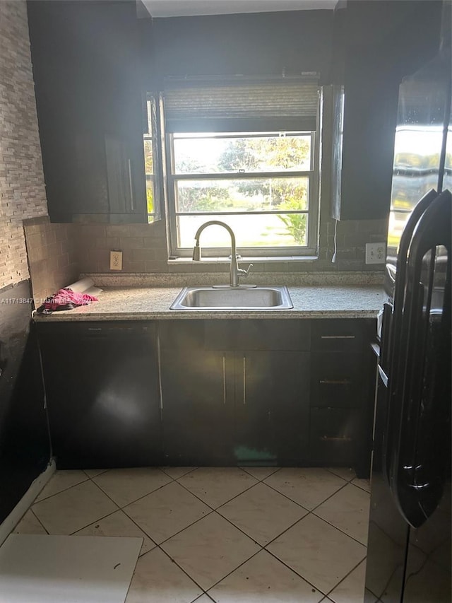 kitchen featuring tasteful backsplash, sink, and fridge