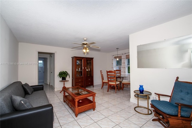 living room with a textured ceiling and ceiling fan