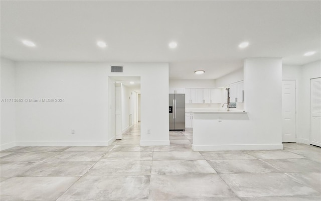 unfurnished living room featuring sink