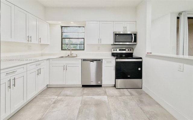 kitchen featuring white cabinets, sink, and stainless steel appliances