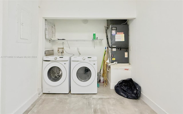 washroom with electric panel, heating unit, and washing machine and clothes dryer