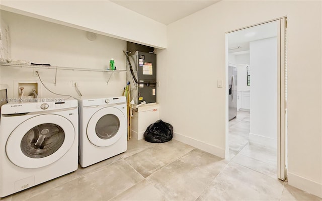 washroom featuring independent washer and dryer and heating unit