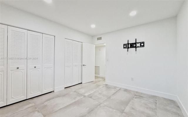 unfurnished bedroom featuring two closets