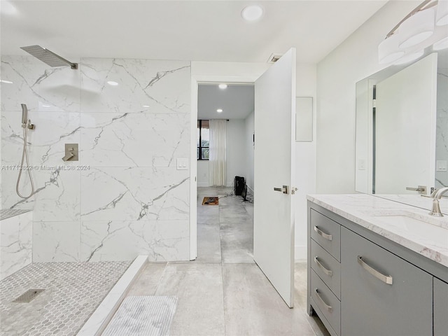 bathroom featuring a shower and vanity