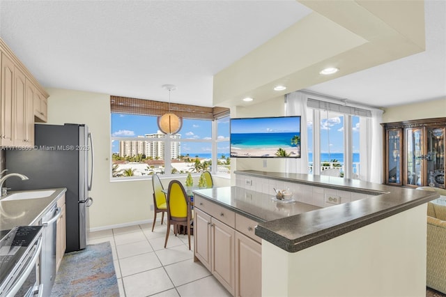 kitchen featuring a center island, light brown cabinets, light tile patterned floors, and sink