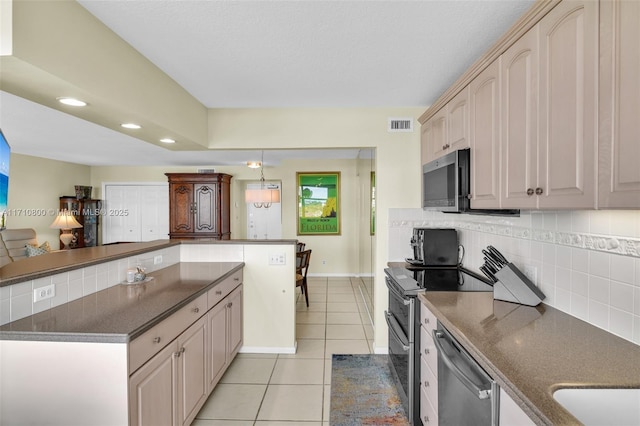 kitchen featuring backsplash, light tile patterned floors, and stainless steel appliances