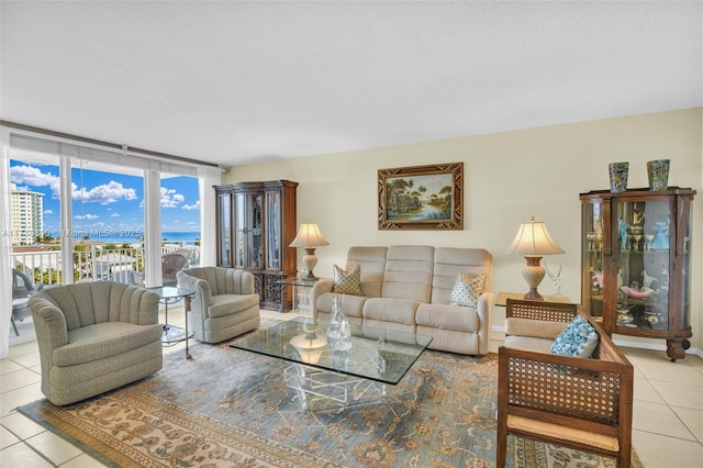 living room featuring light tile patterned flooring and floor to ceiling windows