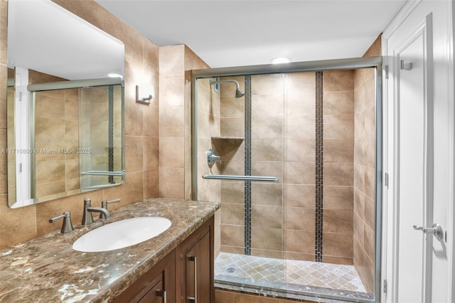 bathroom featuring vanity and an enclosed shower