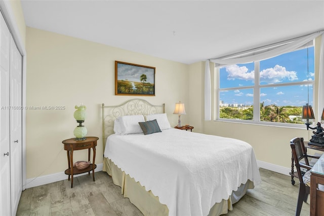 bedroom featuring a closet and light hardwood / wood-style flooring