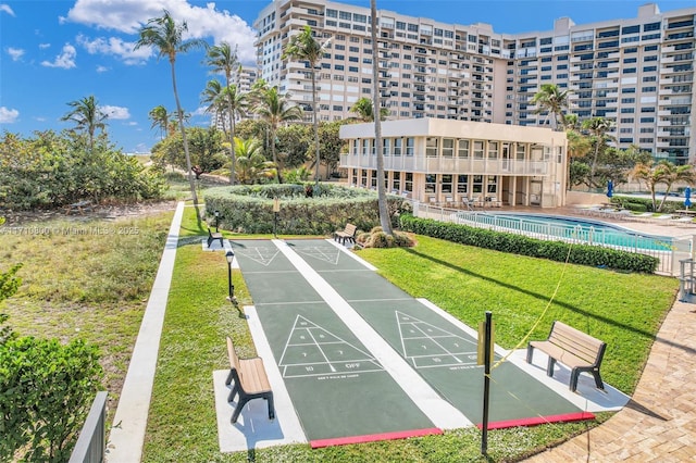 view of property's community with a yard and a swimming pool