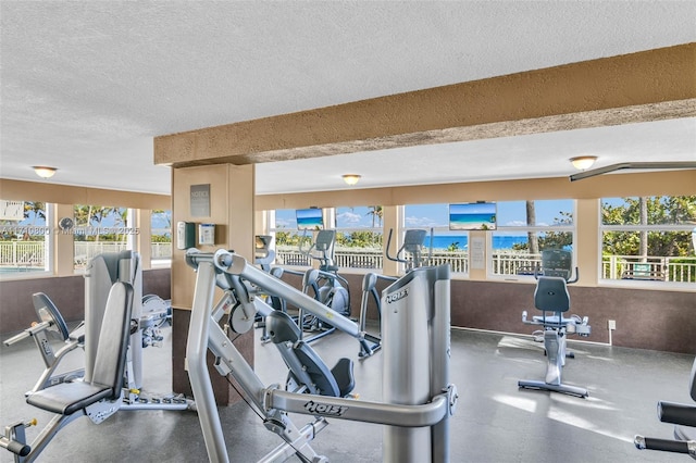 workout area with a textured ceiling and a wealth of natural light