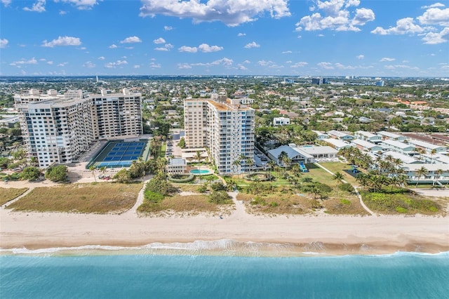 bird's eye view with a water view and a beach view