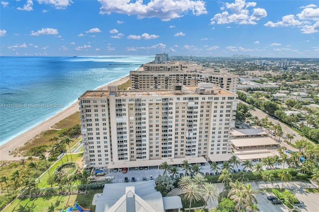 bird's eye view with a water view and a beach view