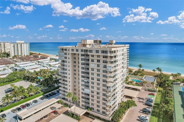 aerial view with a water view and a beach view