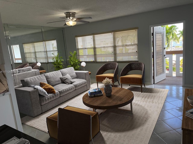 tiled living room featuring ceiling fan and a textured ceiling