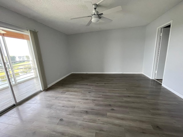 empty room with ceiling fan, dark hardwood / wood-style flooring, and a textured ceiling