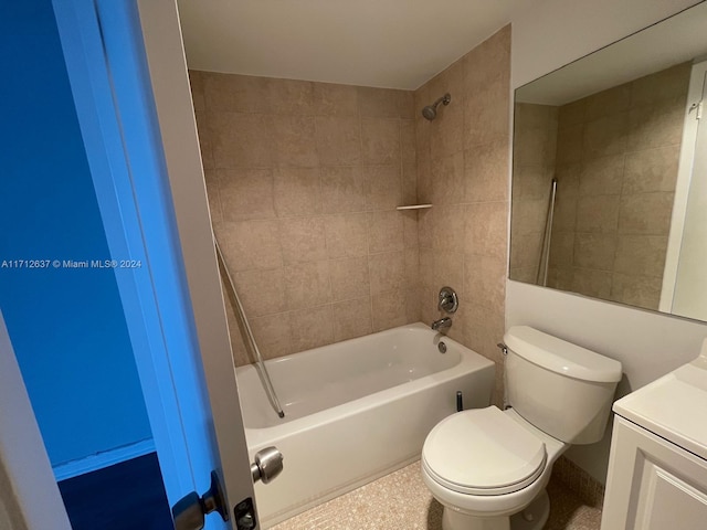 full bathroom featuring tiled shower / bath combo, toilet, and vanity