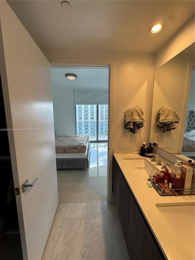 bathroom featuring tile patterned flooring and vanity