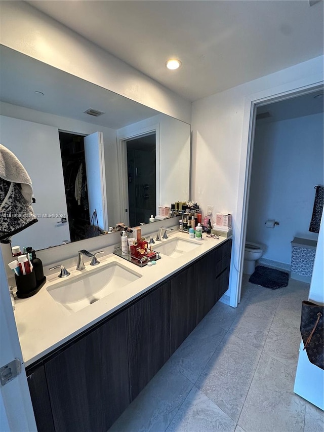 bathroom with tile patterned floors, vanity, and toilet