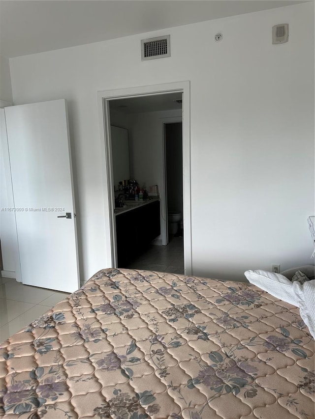 unfurnished bedroom with tile patterned flooring and a closet