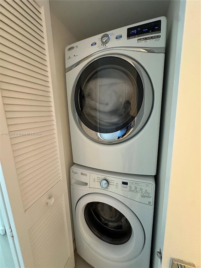 washroom featuring stacked washer and dryer