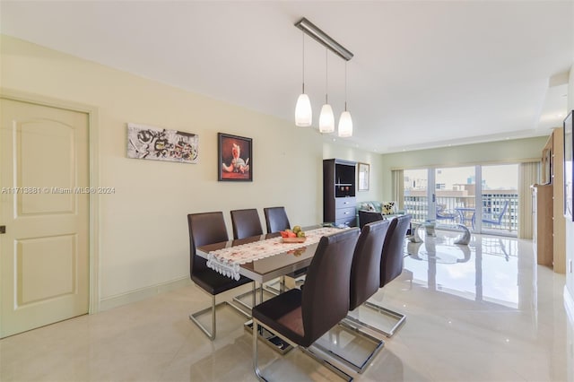 tiled dining area featuring track lighting