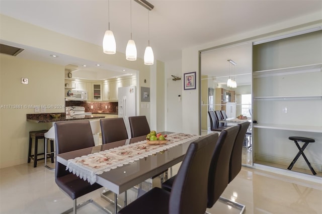 dining space featuring light tile patterned flooring