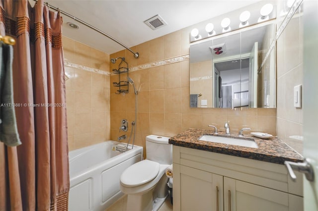 full bathroom featuring vanity, toilet, shower / bathtub combination with curtain, tile walls, and tasteful backsplash