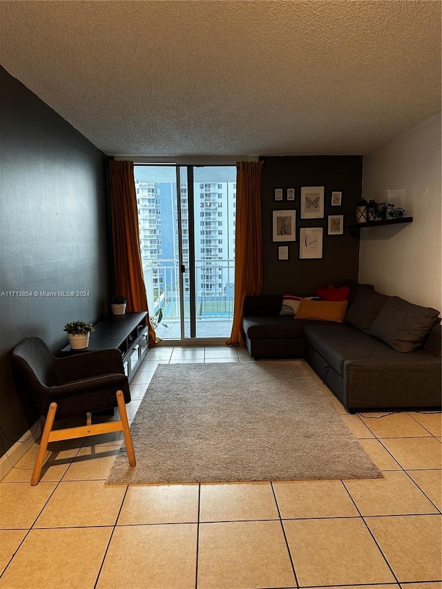 tiled living room with floor to ceiling windows and a textured ceiling