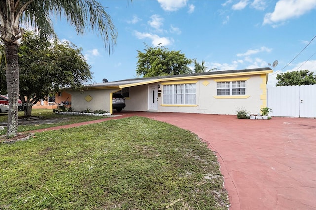 ranch-style home with a front yard and a carport