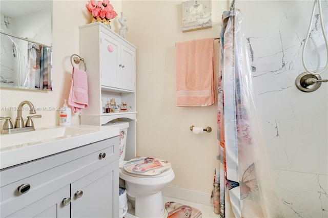 bathroom with vanity, toilet, and walk in shower