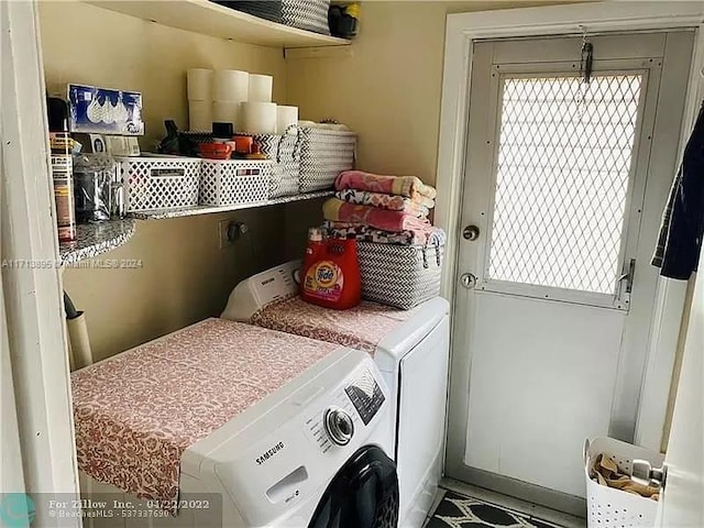 clothes washing area with washing machine and dryer