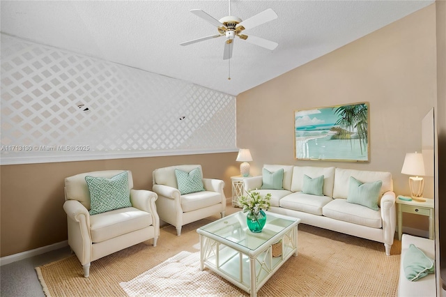 living room featuring vaulted ceiling, light colored carpet, ceiling fan, and a textured ceiling