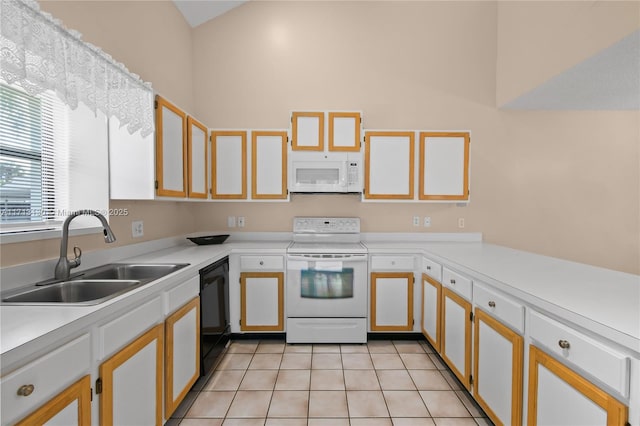 kitchen featuring white cabinetry, sink, white appliances, and light tile patterned flooring