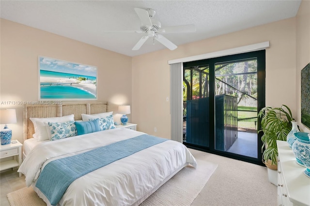 carpeted bedroom with access to exterior, a textured ceiling, and ceiling fan