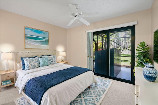 carpeted bedroom with ceiling fan, a textured ceiling, and access to outside