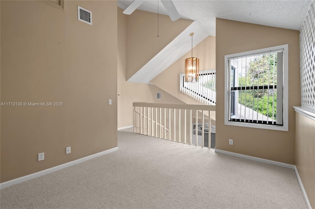 additional living space with a textured ceiling, vaulted ceiling, carpet, and ceiling fan with notable chandelier