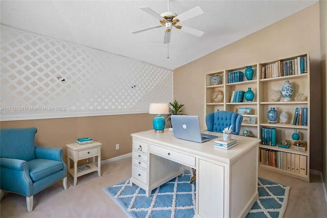 office area featuring lofted ceiling, ceiling fan, light carpet, and a textured ceiling