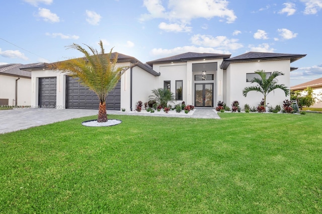 view of front facade featuring french doors, a front lawn, and a garage