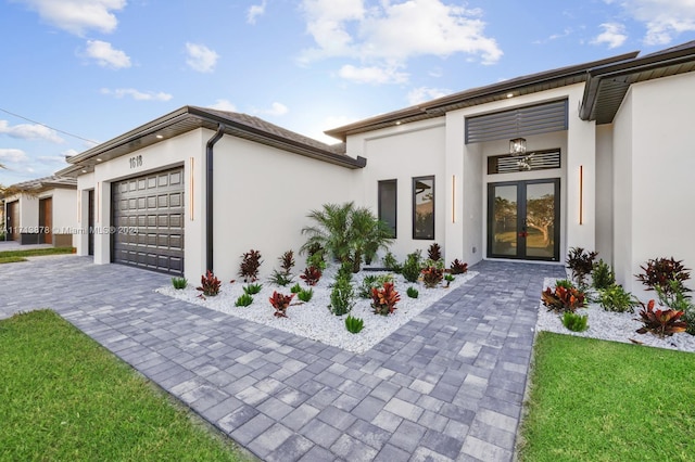 exterior space featuring french doors and a garage