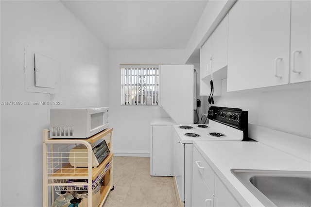 kitchen with white cabinetry, white appliances, sink, and electric panel