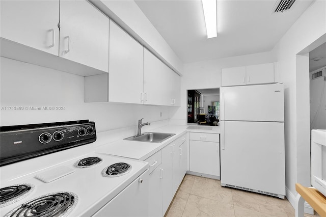 kitchen with range, white cabinetry, sink, and white refrigerator