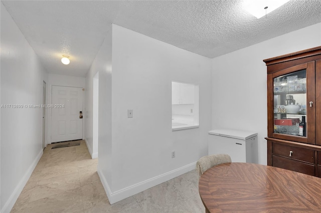 dining area with a textured ceiling